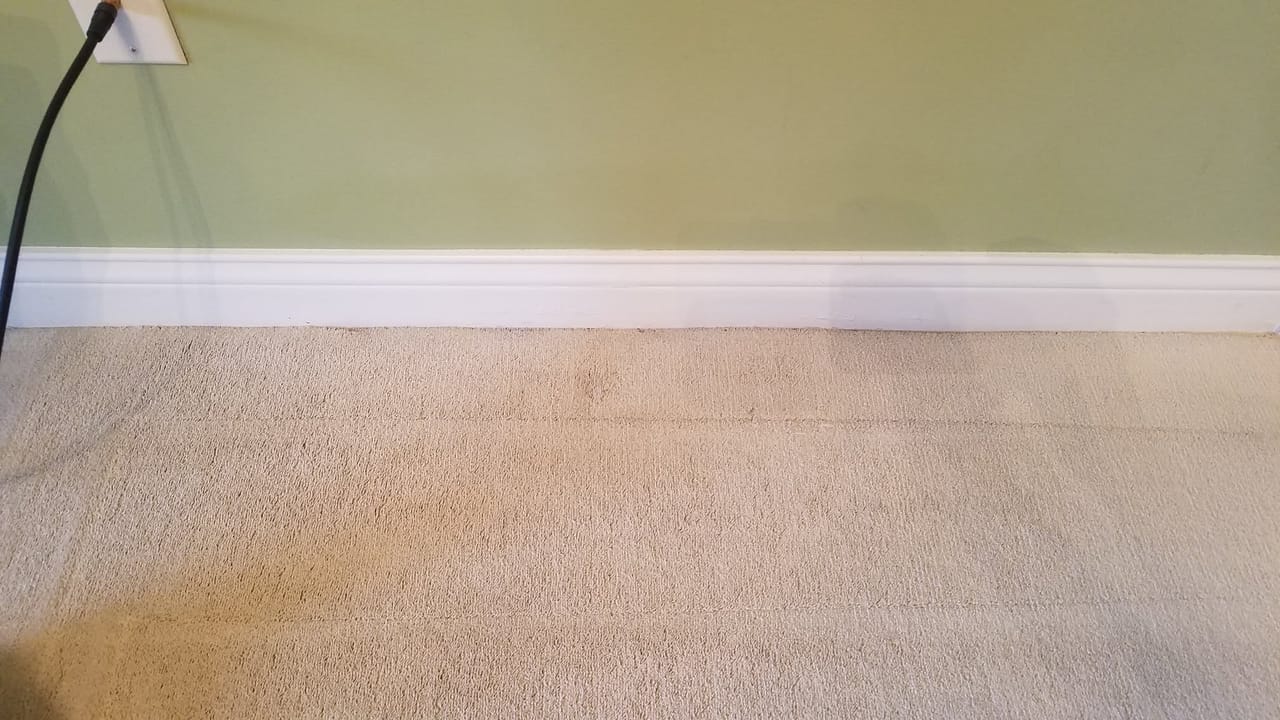 Water stain along a baseboard after