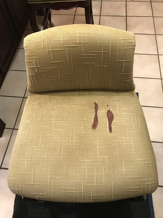 Red stain on a chair cushion before