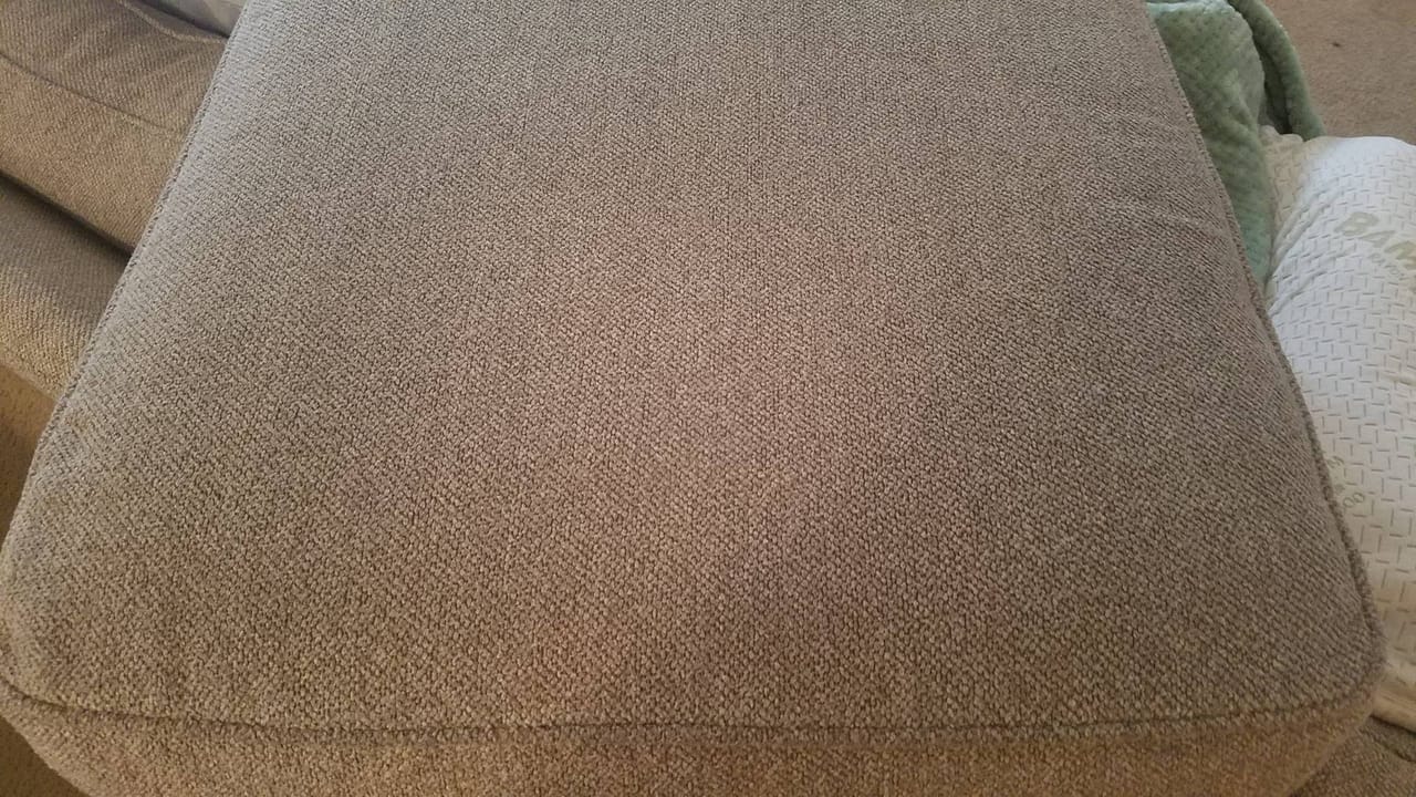Pink stain on a sofa cushion after