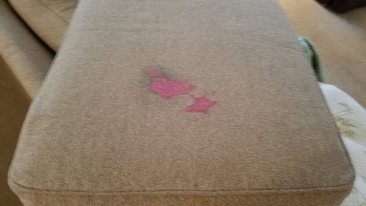 Pink stain on a sofa cushion before
