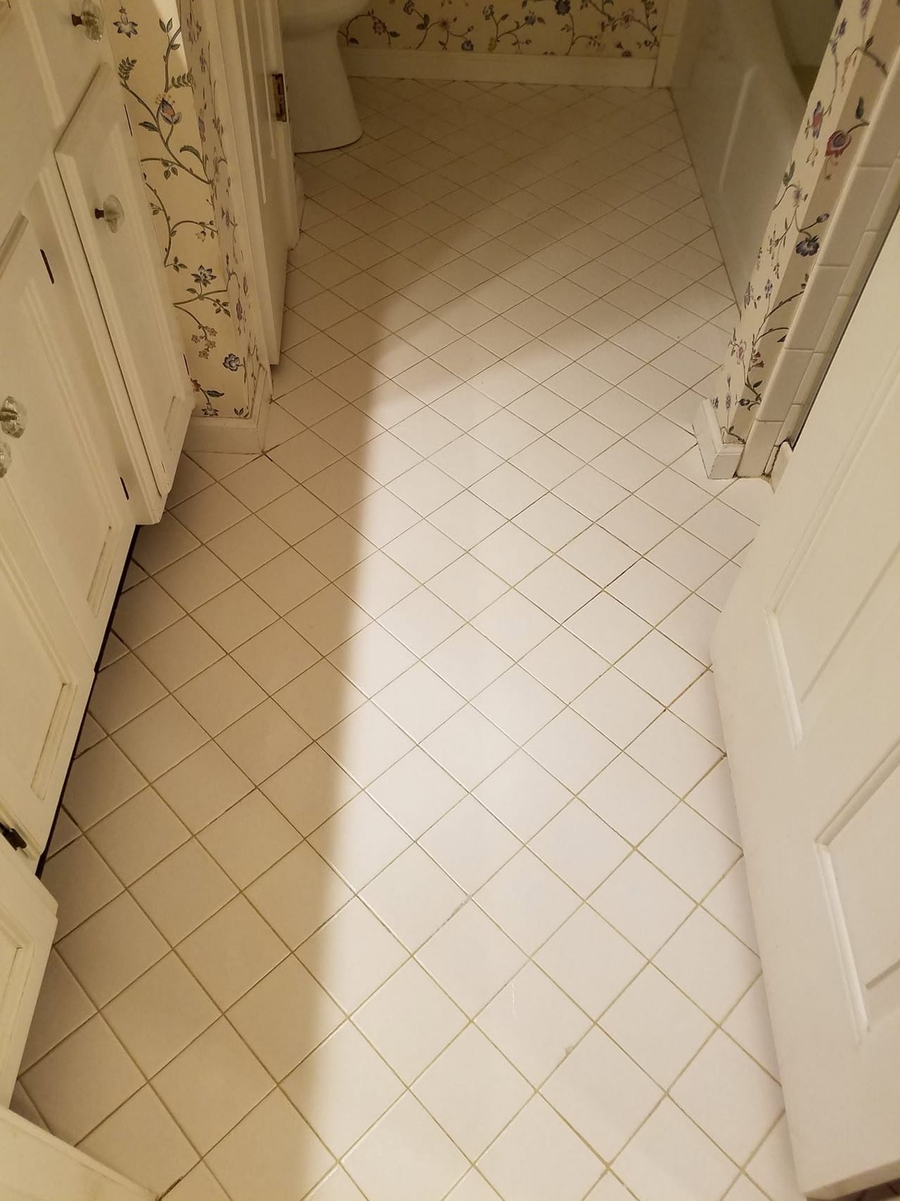 Dark grout lines on bathroom tile after