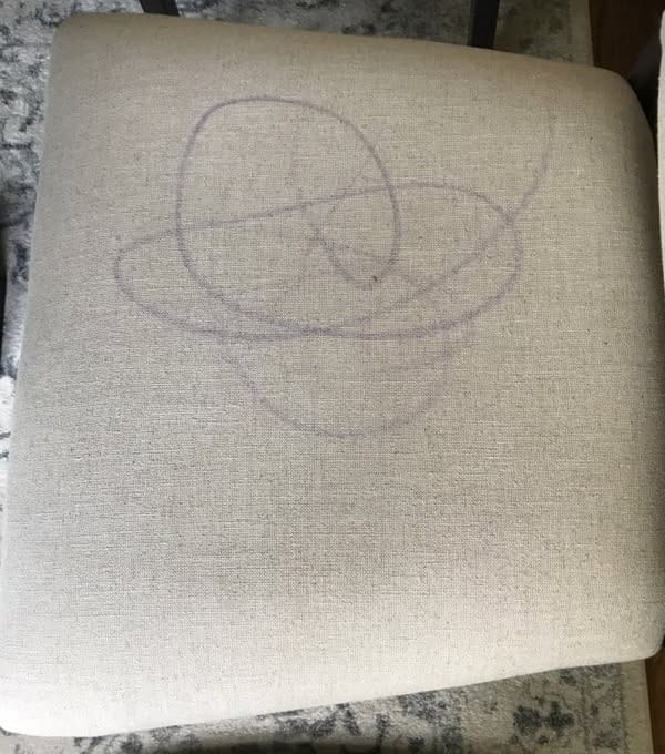 Marker scribbles on a chair seat before