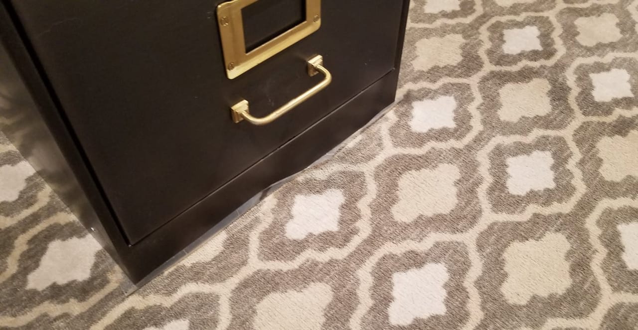 Toner by a file cabinet after