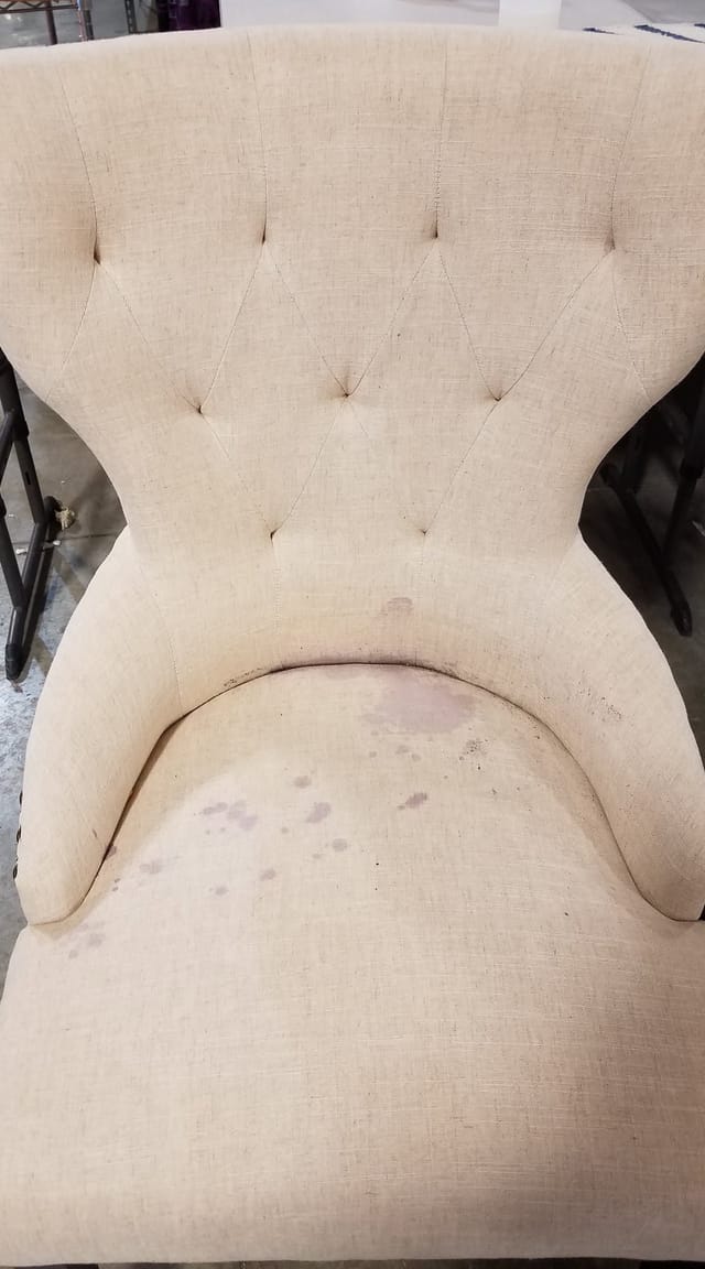 Spots on a tufted chair before cleaning