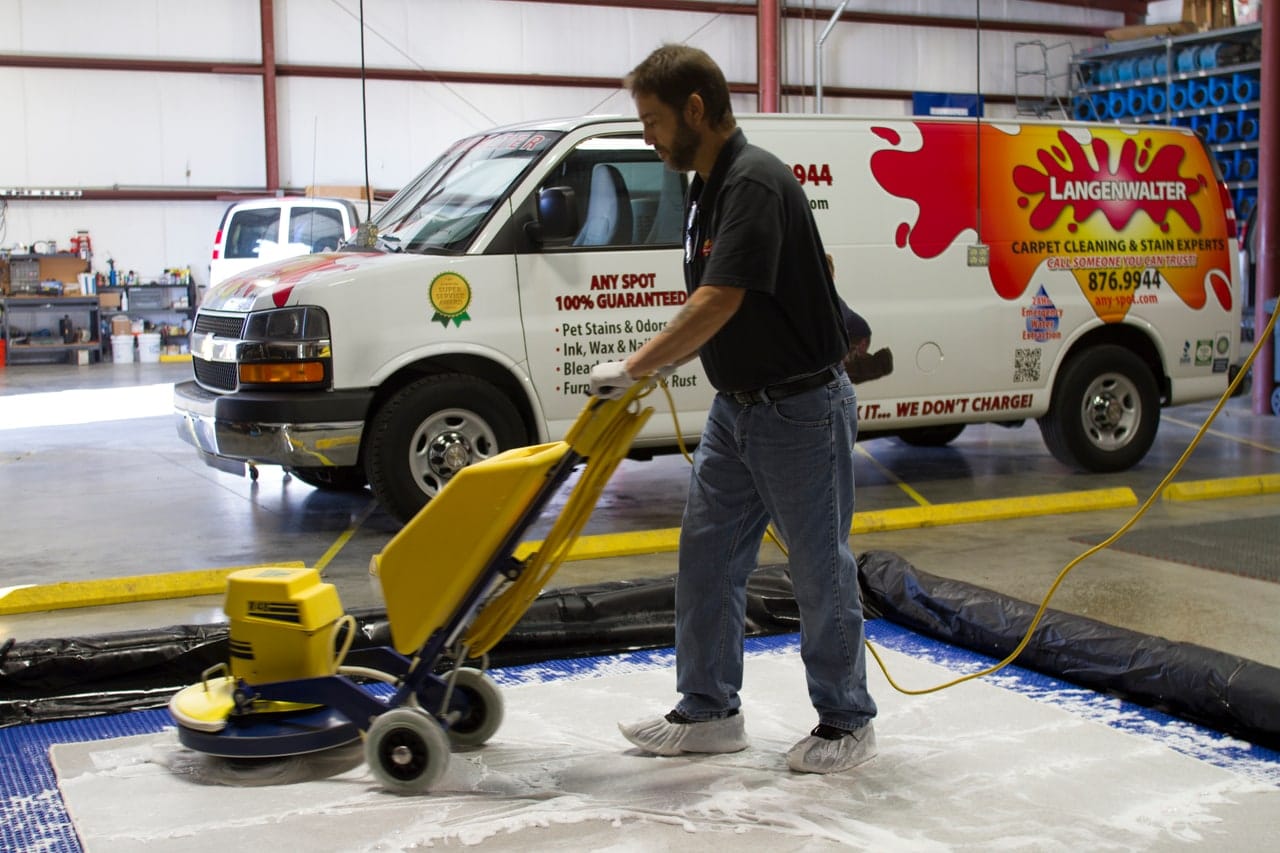 Langenwalter technician scrubbing an area rug in the Carmel shop