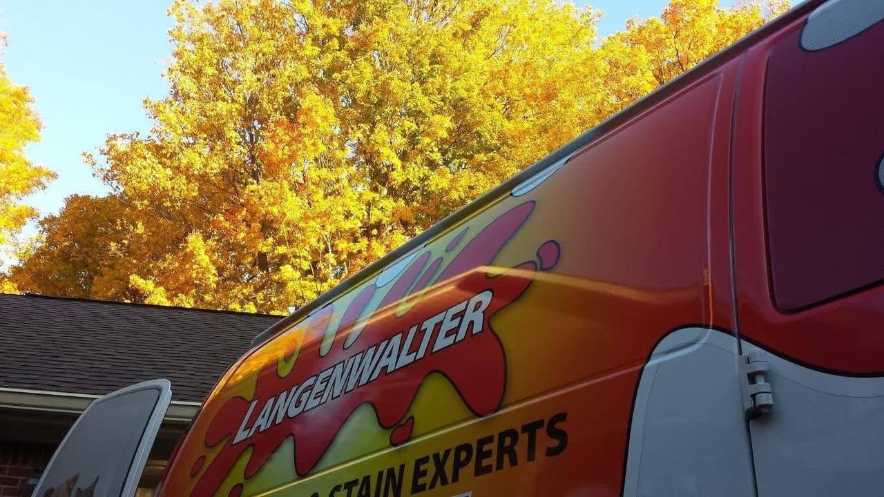 Langenwalter van parked under fall trees at a customer's home